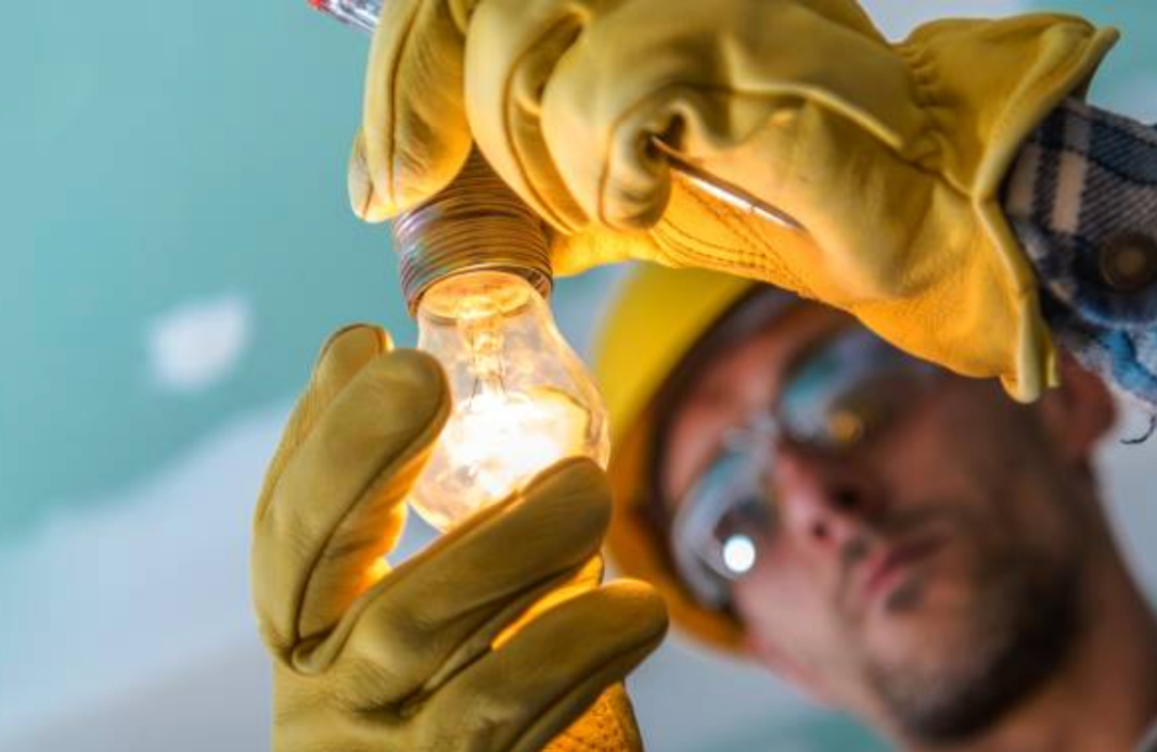 Man holding onto Light-bulb